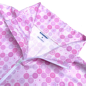 Pink and white patterned fabric with a visible brand label on a white background